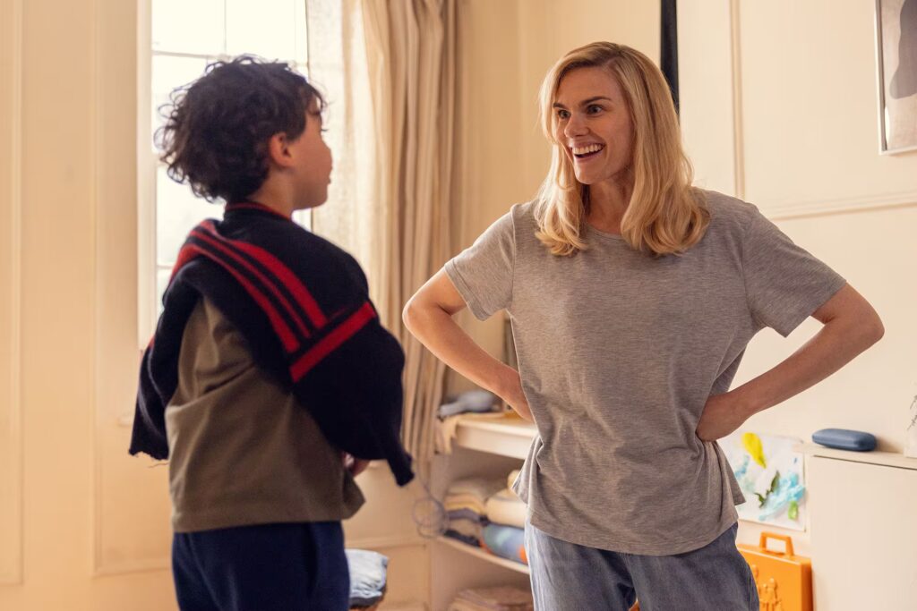 Woman laughing while looking at her child.